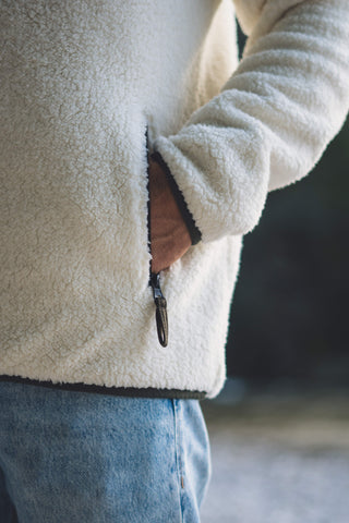 Outdoor Sherpa Plüschjacke Herren mit Tasche in Weiß/Olive.